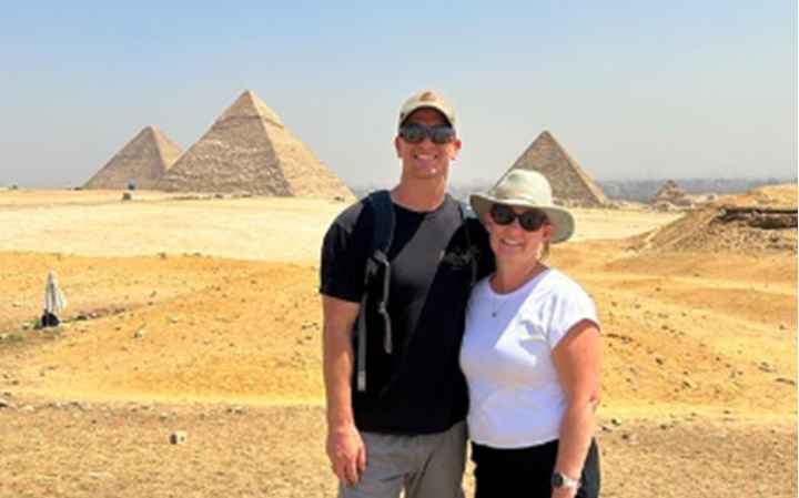 Ben Collins and partner stand in front of Pyramids of Giza