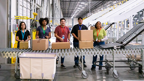 warehouse team packing looking forward and smiling